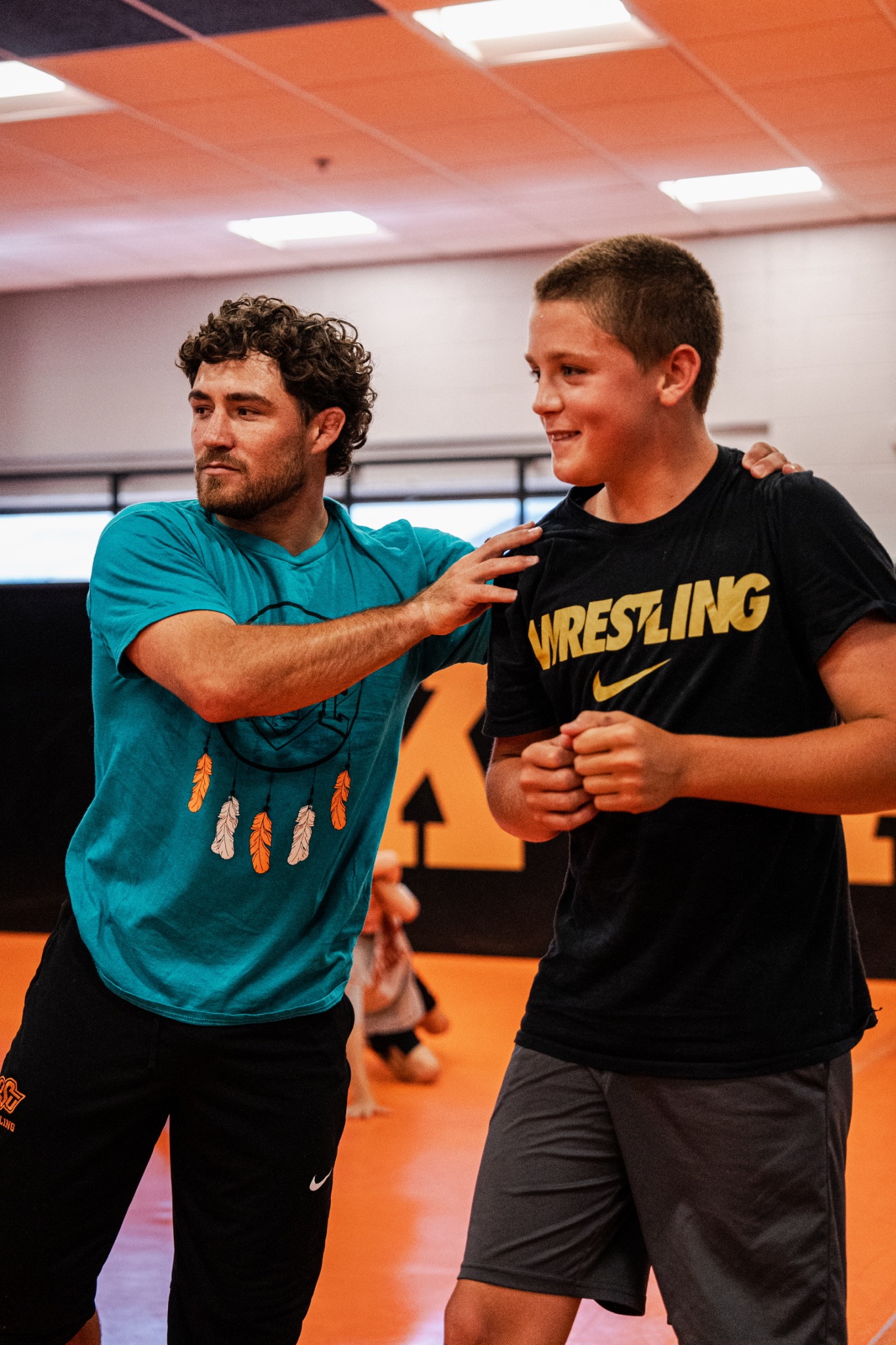 Coach working with young wrestlers